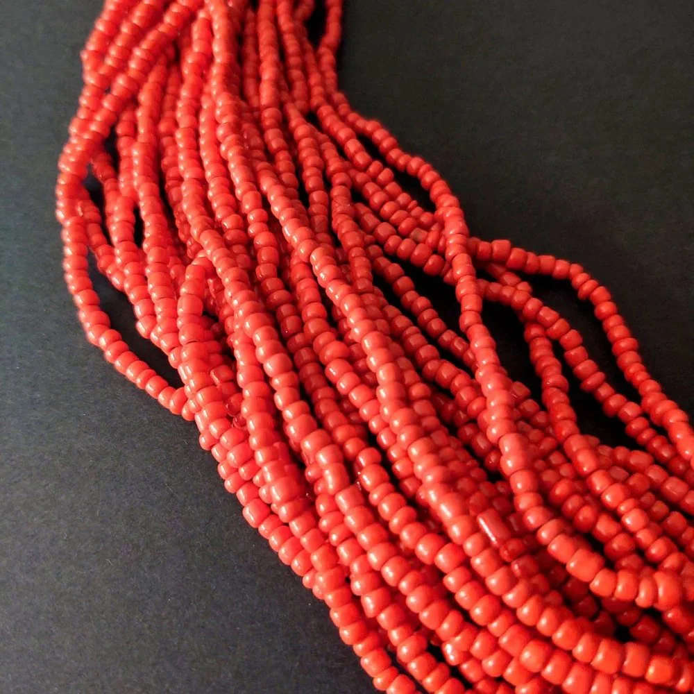 Layered orange beaded necklace with old coin toggle closure